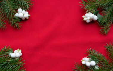 Christmas bouquet with fir branches, red bow and white dogwood berries on a white background . Christmas card. The theme of a winter holiday. Happy New Year