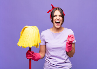 young pretty woman shouting aggressively with annoyed, frustrated, angry look and tight fists,...
