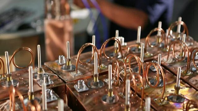 Asian electrical engineer with tools testing computer component