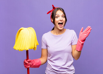 young pretty woman feeling happy, excited, surprised or shocked, smiling and astonished at...
