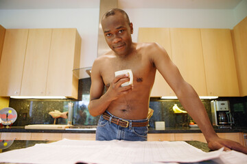Man reading newspaper and drinking coffee