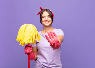 young pretty woman smiling and looking friendly, showing number four or fourth with hand forward,...