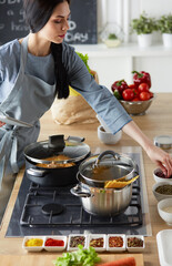 Woman baking at home following recipe on a tablet