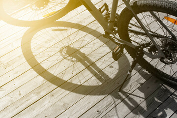 bike shadow on old wood texture, front and background blurred with bokeh effect