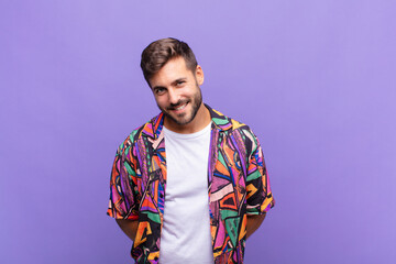young man looking proud, confident, cool, cheeky and arrogant, smiling, feeling successful