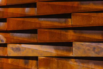 Close-up of brown metal tiled wall. Rustic rectangular pieces creating pattern