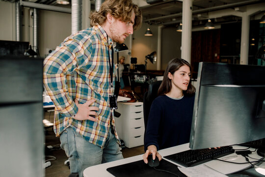 Business people discussing about programming at workplace