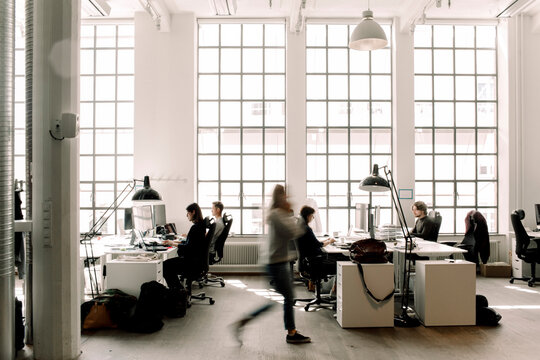 Male and female professional coworkers working in office