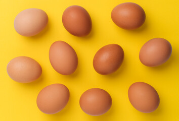 brown eggs on yellow background