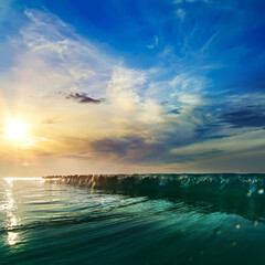 Beautiful sunset at the sea at south summer coast and colorful green blue wave line