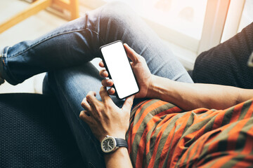 cell phone mockup blank white screen.man hand holding texting using mobile on desk at coffee shop.background empty space for advertise.work people contact marketing business,technology