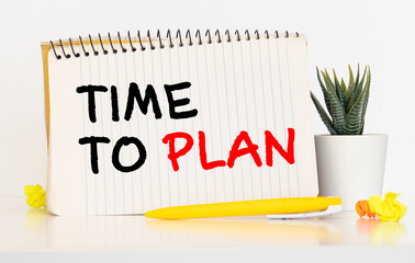 Time for planning - on sticky note with crumpled papers on wooden background.