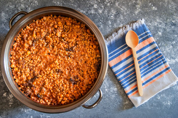 Turkish traditional food keskek in steel pot, made from wheat grains, chickpeas and meat, delicious turkish cuisine concept