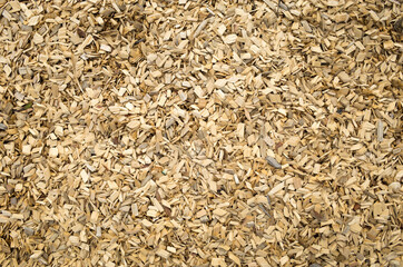 View from the top of the background texture of light color wooden chips/playground mulch covered the ground.