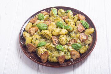 Homemade potatoes gnocchi with basil , cheese and mushrooms