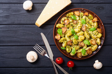 Homemade potatoes gnocchi with basil , cheese and mushrooms