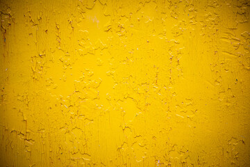 Yellow paint painted on rough wall background