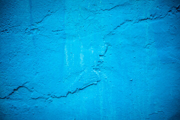 Blue paint painted on rough wall background