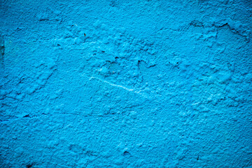 Blue paint painted on rough wall background