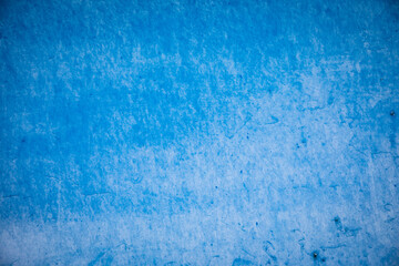 Blue paint painted on rough wall background