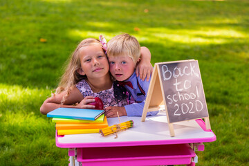 A schoolgirl and a schoolboy with an apple