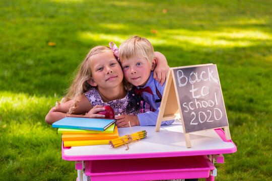 A schoolgirl and a schoolboy with an apple - Powered by Adobe