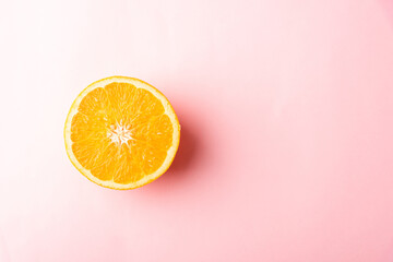 Top view of Fresh half orange fruit slice in the studio shot isolated on pink background, Healthy food concept