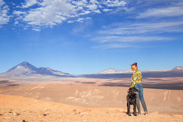 Fototapeta premium woman with her dog in a desert landscape
