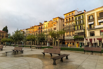 Naklejka premium Dawn in the Castle square, with sunlight on the buildings, Pamplona municipality, capital of the province of Navarra, Spain