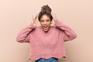 young afro woman feeling disgusted and nauseous, backing away from something nasty, smelly or...