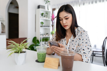 woman using smartphone in cafe