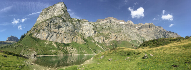panorama of Oberblegisee lake in Swiss Alps with blue sky and copy space, Glarus Canton, Switzerland