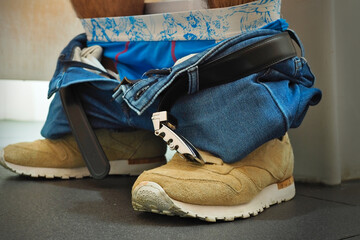 Man sitting inside toilet with underwear and pants down. Diarrhea concept. 