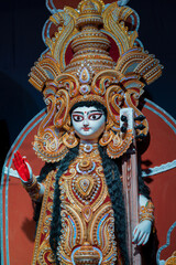 Fototapeta premium Goddess Saraswati idol , Durga Puja festival at night. Shot under colored light at Howrah, West Bengal, India. Biggest festival of Hinduism , celebrated all over the world.