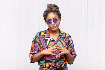 young afro woman scheming and conspiring, thinking devious tricks and cheats, cunning and betraying