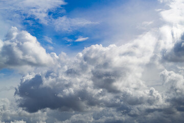 Fototapeta na wymiar The blue sky shines through the clouds. Beautiful white cumulus clouds in the blue sky