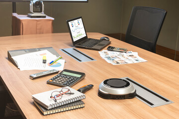 Laptop and meeting equipment on table in video conference meeting room (Work from home Concept)