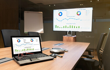 Close up laptop on table with Presentation meeting on television in Video conference meeting room...