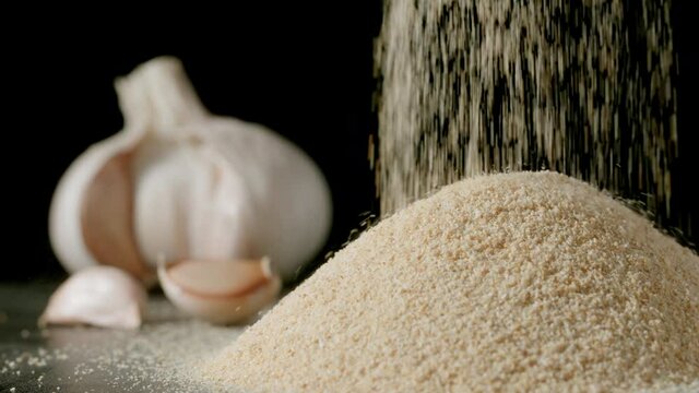 White garlic grains falling in a pile