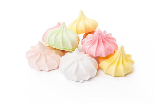 Pile of colorful meringue cookies isolated on white