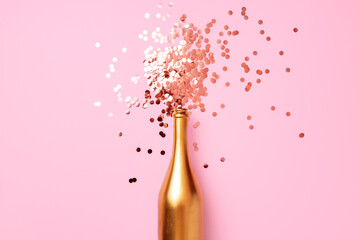 Champagne bottle with confetti flat lay top view