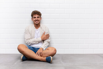 young man laughing shyly and cheerfully, with a friendly and positive but insecure attitude