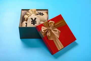 side view gift box full with RMB money bags on blue background