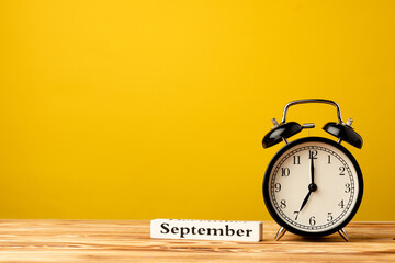 Back to school concept with alarm clock