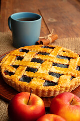 Close up of homemade traditional sweet autumn raspberry tart pie on wooden table