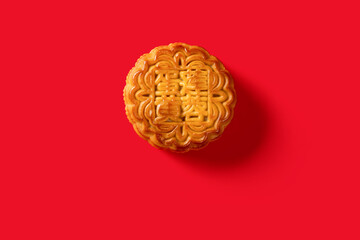 translation of the Chinese to English-lotus seed paste with yolk-top view traditional mooncake on red no logo or trademark
