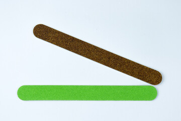 Manicure tools. Nail files isolated on a white background. The view from the top. Green nail file. Purple nail file.