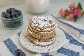 Home made lemon pancakes with poppy seeds on a breakfast table