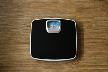 Black color Weight machine in a wooden background