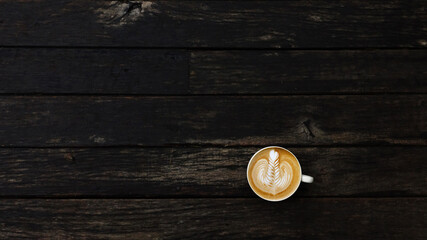 Fototapeta na wymiar a cup of latte art coffee on wooden background 